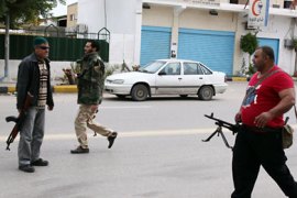 Libyans gunmen roam along Zawiyah Street in the Libyan capital Tripoli on January 3, 2012,