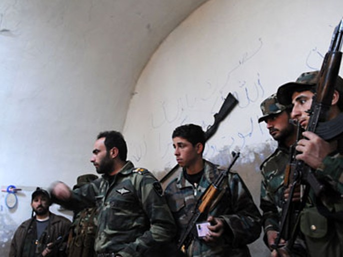 Armed Free Syrian Army rebels gather in the north Syrian city of Idlib on February 16, 2012. Syrian armour moved on the main hubs of an 11-month uprising with at least 22 killed in clashes, monitors said, a day after President Bashar al-Assad set a vote for a new constitution.