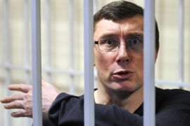 Yuriy Lutsenko (L), former Ukrainian interior minister ally of the jailed ex-prime minister Yulia Tymoshenko gestures from a caged area inside the court during a verdict hearing in Kiev on February 27, 2012. Lutsenko, who was arrested in December 2010 and has been held in detention ever since, was found guilty by a district court in Kiev of abusing his powers while in office was sentenced to four years in jail in a trial denounced by her supporters as politically motivated.