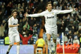 Real Madrid's Portuguese forward Cristiano Ronaldo (R) celebrates after scoring during the Spanish League football match Real Madrid vs Levante at the Santiago Barnabeu stadium in Madrid on February 12, 2012. AFP