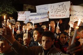 Palestinian schoolchildren hold up candles during a portest in Gaza City calling for supplying the Gaza Strip with enough fuel on February 14, 2012. The impoverished territory's sole power plant, which supplies around a third of Gaza's electricity, ground to a halt after it ran out of diesel, an energy authority official said, calling on Egypt to intervene to resolve the crisis.
