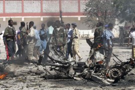 Government policemen inspect the scene of an explosion in Hodan district of Somalia's capital Mogadishu February 17, 2012