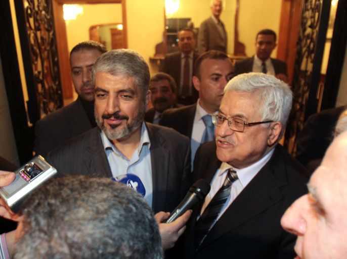 Hamas leader Khaled Meshaal (L) stands along side Palestinian president Mahmud Abbas as they speak to the press in the Egyptian capital Cairo, on February 22, 2012, after talks on the formation of a national unity government, an AFP reporter said. AFP PHOTO/ STR