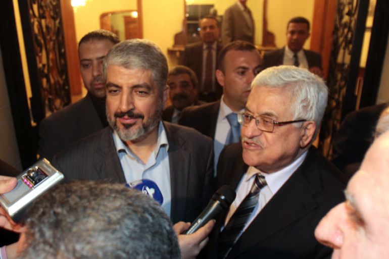 Hamas leader Khaled Meshaal (L) stands along side Palestinian president Mahmud Abbas as they speak to the press in the Egyptian capital Cairo, on February 22, 2012, after talks on the formation of a national unity government, an AFP reporter said. AFP PHOTO/ STR