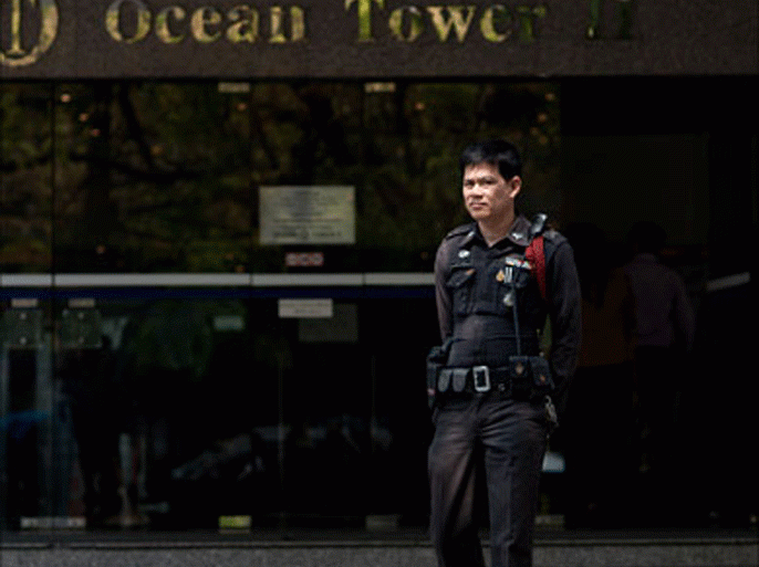 A Thai police officer stands guard outside the building where the Israeli embassy is located a day after multiple explosions in Bangkok on February 15, 2012