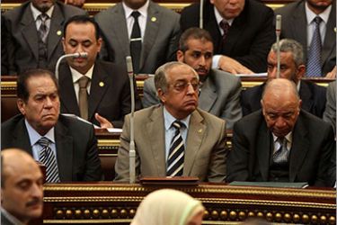 Egyptian Prime Minister Kamal al-Ganzuri (L) and Interior Minister Mohammed Ibrahim (C) attend an emergency parliament session in Cairo on February 2, 2012 to discuss the previous day's deadly clashes after a football match. Egypt began three days of mourning after 74 people were killed in an eruption of violence at a football match in Port Said that sparked new anger against the military rulers for failing to ensure security. AFP PHOTO/ STR