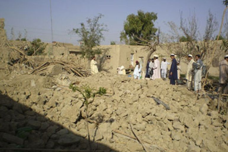 Tribesmen gather at a site of a missile attack on the outskirts of Miranshah, near the Afghan border, October 12, 2008. Suspected U.S. drones fired two missiles on Saturday into a Pakistani region regarded as a safe haven for al Qaeda and Taliban militants, killing at least five insurgents, residents and an intelligence official said. REUTERS/Haji Mujtaba (PAKISTAN