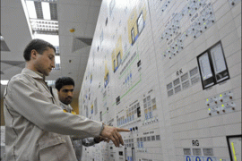 r : EDITORS' NOTE: Reuters and other foreign media are subject to Iranian restrictions on their ability to film or take pictures in Tehran. An Iranian operator (R) and a Russian operator monitor the nuclear power plant unit in Bushehr,