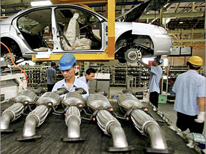 Chinese workers produce cars at the assembly line at the Changan Ford car factory in Chongqing in this May 27, 2005 file photo. Changan Ford is a 50-50 joint venture of Ford Motor Co with Chinese local car maker Changan Automobile Co