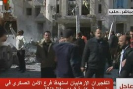 An image grab taken off the official Syrian TV shows security forces and onlookers inspecting at the scene of a blast in Syria's second largest city of Aleppo on February 10, 2012. Three explosions rocked Aleppo, activists said, adding that one of the blasts was near a military intelligence building, while Syrian state television blamed "armed terrorist gangs" for two explosions in the city and reported a number of casualties, including soldiers.