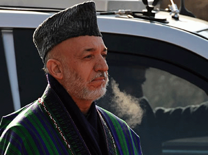 President Karzai listens to national anthem on the opening session of the Parliament in Kabul on January 21, 2012. Speaking shortly after Grossman's arrival, Karzai reiterated that his government accepted the plan for a Qatar office "for the purpose of peace". He noted that his government had also recently met a delegation from the second biggest insurgent group, Hizb-e-Islami, "in brotherhood and good atmosphere" and