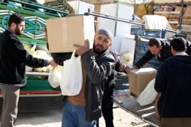 Syrian refugees, who fled the unrest in Syria, receive humanitarian aid in the Jordanian city of Al Ramtha December 15, 2011.