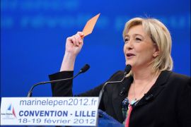 President of French far-right party Front national (FN) and candidate for the 2012 French presidential election, Marine Le Pen, holds a red card during a speech on the second day of the party's convention in Lille, northern France, on February 19, 2012. Marine Le Pen brandished a red card for France's President and Union for a Popular Movement (UMP) candidate for 2012 presidential election, Nicolas Sarkozy, urging voters to "sanction" him in the 2012 presidential polls. AFP PHOTO/PHILIPPE HUGUEN