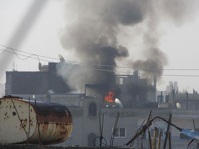 A handout picture released by the Local Coordination Committee in Syria (LCC Syria) shows fire and smoke rising from buildings in the Baba Amro neighbourhood of the opposition city of Homs during an attack by Syrian forces on February 21, 2012