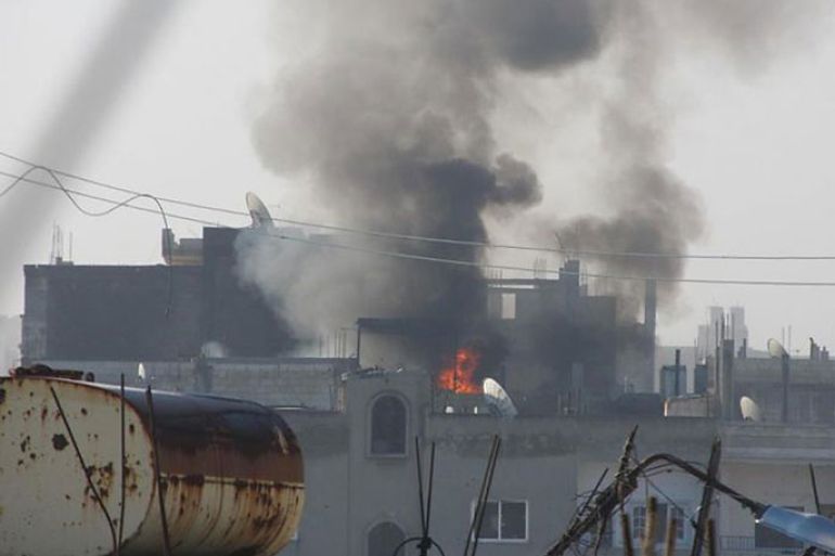 A handout picture released by the Local Coordination Committee in Syria (LCC Syria) shows fire and smoke rising from buildings in the Baba Amro neighbourhood of the opposition city of Homs during an attack by Syrian forces on February 21, 2012