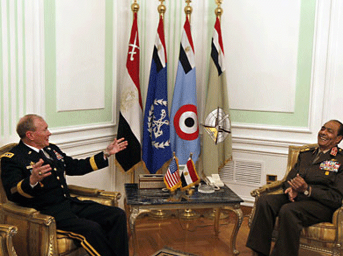 Field Marshal Mohammed Hussein Tantawi, head of Egypt's ruling military council, (R) shares a laugh with US General Martin Dempsey, chairman of the Joint Chiefs of Staff, during a meeting at the ministry of defence in Cairo on February 11, 2012. Activists called for a day of strikes in Egypt to mark exactly a year since they toppled Hosni Mubarak, leaving an increasingly unpopular and defiant military in charge. AFP PHOTO/POOL/KHALIL HAMRA