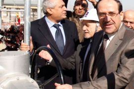 Iraq's Prime Minister Nuri alMaliki opens an oil pipe valve during the inauguration of a new Single Point Mooring (SPM) outlet in Iraq's southern province of Basra February 12, 2012