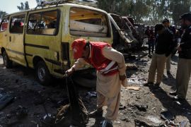 Peshawar, -, PAKISTAN : Pakistani policemen inspect the site of a car blast on the outskirts of Peshawar on February 23, 2012. A car bomb ripped through a Pakistani bus station on February 23, killing 12 people, including two children on the outskirts of the northwestern city of Peshawar, officials said. AFP PHOTO / A. MAJEED