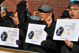 Anti-war activists hold placards during a rally against the Key Resolve joint military exercise between South Korea and the United States outside a US Army base in Seoul on February 27, 2012