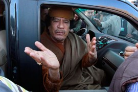 Libyan leader Muammar Gaddafi waves from a car in the compound of Bab Al Azizia in Tripoli, after a meeting with a delegation of five African leaders seeking to mediate in Libya's conflict, April 10, 2011. Gaddafi, making his first appearance in front of the foreign media in weeks, joined a visiting African Union delegation at his Bab al-Aziziyah compound in Tripoli on Sunday