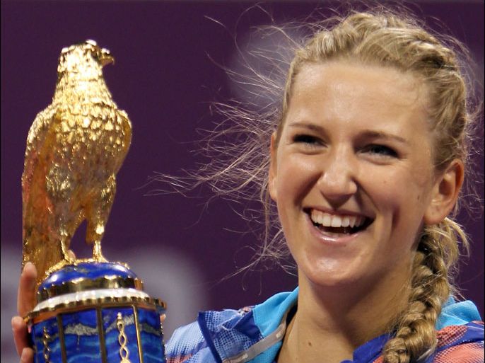 Belarus' Victoria Azarenka poses with the trophy after beating Samantha Stosur of Australia in their Qatar WTA Tennis Open final tennis match in Doha on February 19, 2012. Azarenka won 6-1, 6-2, her third successive title of the year at the WTA Qatar Open, taking her 2012 record to 17 straight wins. AFP PHOTO/KARIM JAAFAR