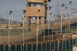 In this photo reviewed by US military officials, a US military member mans one of the watch towers at Camp Delta at the US Detention Center in Guantanamo Bay, Cuba on March 30, 2010.