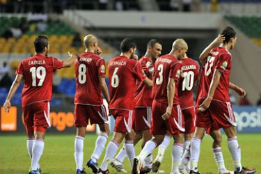 ف-Morocco's national football team players celebrate after a goal against Niger at the stade de l'Amitie on January