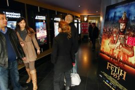 Turkish filmgoers are pictured next to a poster of "Fetih 1453" or "Conquest 1453", depicting the conquest of Istanbul by Ottoman Turks at a cinema in Ankara on February 27, 2012. Since it was first screened on February 16 at a symbolic time of 14:53, some 2.5 million viewers have watched the film, according to Box Office Turkey statistics.
