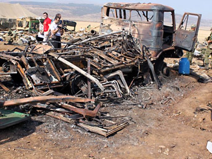 Russian investigators work on the site of an explosion at a military firing ground "Dalny" outside the town of Buinaksk in Dagestan on September 5, 2010