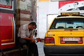 r_A Syrian taxi driver fills up a car with petrol at a station in Damascus September 21, 2010. The Syrian government on Tuesday announced a 10 percent hike in petrol prices following