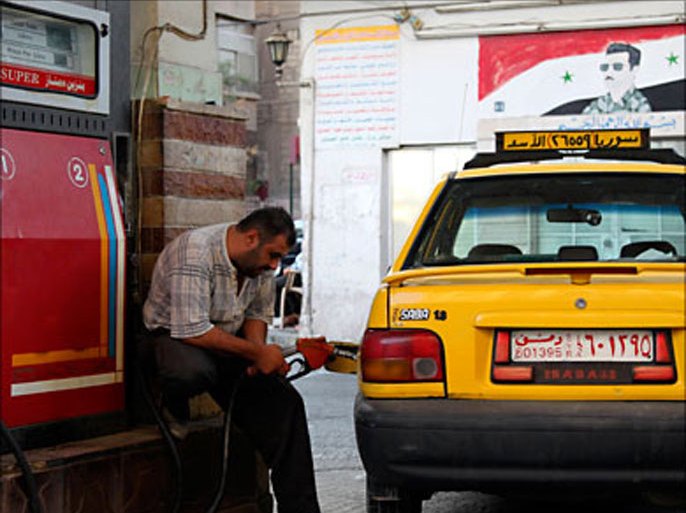 r_A Syrian taxi driver fills up a car with petrol at a station in Damascus September 21, 2010. The Syrian government on Tuesday announced a 10 percent hike in petrol prices following