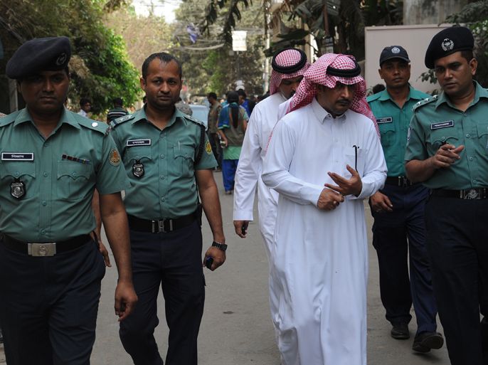 Bangladeshi policemen and officials from the Royal Embassy of Saudi Arabia inspect the area where a Saudi Arabian diplomat was shot dead in Dhaka on March 6, 2012. Police found Khalaf Al Ali's body at an intersection just two buildings away from his residence in the city's upmarket Gulshan district and rushed him to a hospital where he died three hours later, Lutful Kabir said.