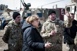 German Chancellor Angela Merkel (C) talks with German soldiers as she visits Camp Marmal, the German troops' base in Mazar-i-Sharif, on March 12, 2012. Merkel arrived in Afghanistan for a surprise visit, with tensions running high a day after a US soldier went on a rampage, killing 16 villagers. Germany is the third biggest supplier of troops to the 130,000-strong NATO-led International Security Assistance Force (ISAF) after the United States and Britain.