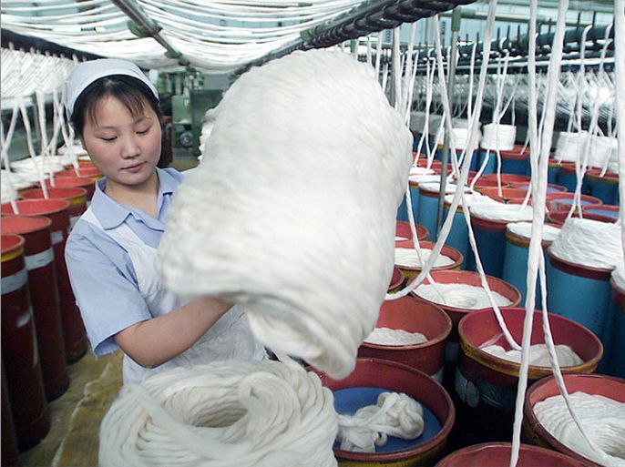 Picture made available on Thursday, 22 May 2003, of workers at the Shanghai Yarn No17 cotton yarn factory, producing 80,000 meters of the yarn per day for face masks supposed to protect people from catching Severe Acute Respiratory Syndrome (SARS). The World Health Organisation said Thursday it was concerned about the number of SARS patients in China who fell ill despite having no reported contact with other SARS sufferers. EPA-PHOTO/IMAGECHINA/Gao Feng