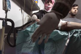 A wounded Syrian man receives medical treatment at a makeshift hospital in the restive northern Syrian Idlib region on March 18, 2012.