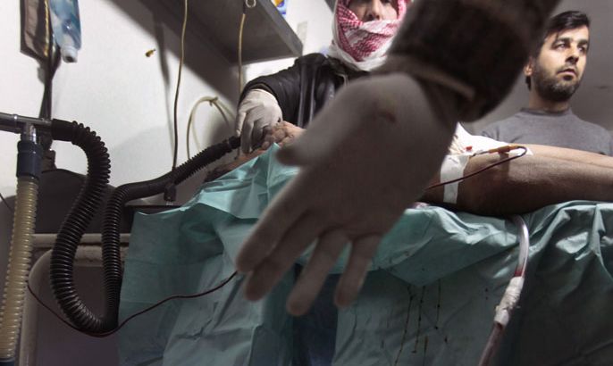 A wounded Syrian man receives medical treatment at a makeshift hospital in the restive northern Syrian Idlib region on March 18, 2012.