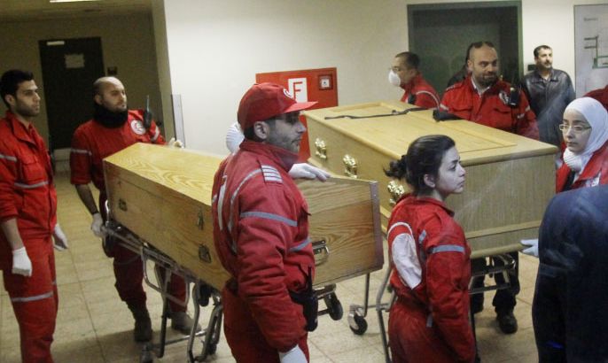 The coffins of French photojournalist Remi Ochlik and American journalist Marie Colvin of the Sunday Times are wheeled in a hospital in Damascus on March 3, 2012. Human Rights Watch painted a harrowing picture of Homs, saying some 700 people were killed, including Colvin and Ochlik, and thousands wounded by regime forces in a 27-day blitz, with shells sometimes falling at the rate of 100 an hour. AFP PHOTOANWAR AMRO