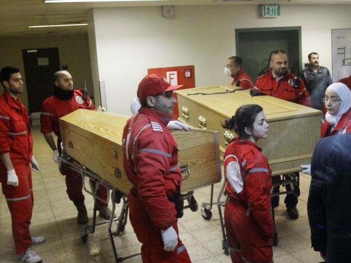 The coffins of French photojournalist Remi Ochlik and American journalist Marie Colvin of the Sunday Times are wheeled in a hospital in Damascus on March 3, 2012. Human Rights Watch painted a harrowing picture of Homs, saying some 700 people were killed, including Colvin and Ochlik, and thousands wounded by regime forces in a 27-day blitz, with shells sometimes falling at the rate of 100 an hour. AFP PHOTOANWAR AMRO