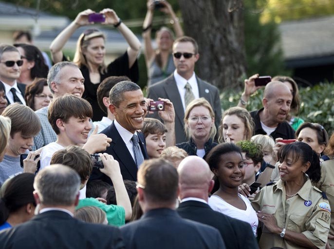 President Barack Obama poses with people outside the home where he is attending a private campaign event March 16, 2012 in Atlanta. President Obama is spending the day traveling to Chicago, Illinois and Atlanta