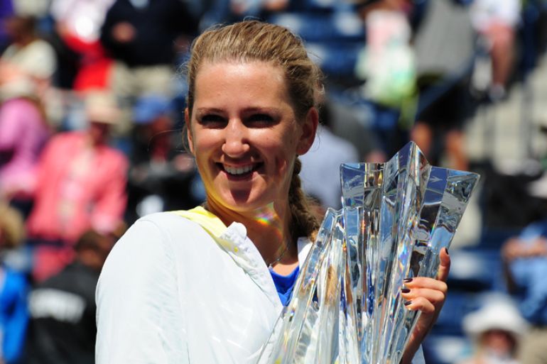 Victoria Azarenka of Belarus poses with the winner's trophy after defeating Maria Sharapova of Russia the final of the BNP Paribas Open at the Indian Wells Tennis Garden on March 18, 2012 in Indian Wells, California. Azarenka won 6-2, 6-3.