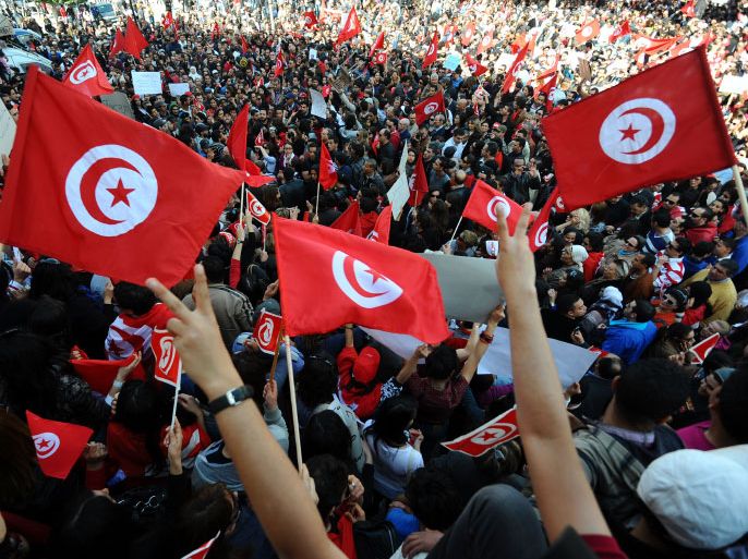 Tunisians holding their country's flags shout during a demostration on March 20, 2012 in Tunis. Tunisians celebrated their country's independence day Tuesday amid fears of a widening divide between secular and religious movements in the newly democratised nation. "This festival is an opportunity for us all to rethink our relationships, to live with our differences and despite our differences," President Moncef Marzouki told a flag-raising ceremony at the presidential palace in Carthage. AFP PHOTO / FETHI BELAID