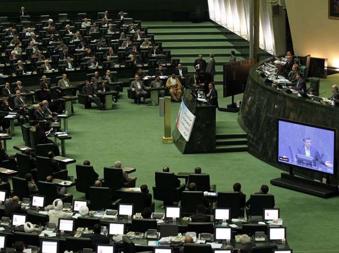 Iranian President Mahmoud Ahmadinejad addresses the parliament in Tehran on March 14, 2012. Ahmadinejad gave a defiant and at times mocking defence of his economic and political management in an unprecedented interrogation by a largely hostile parliament. AFP PHOTO/ATTA KENARE