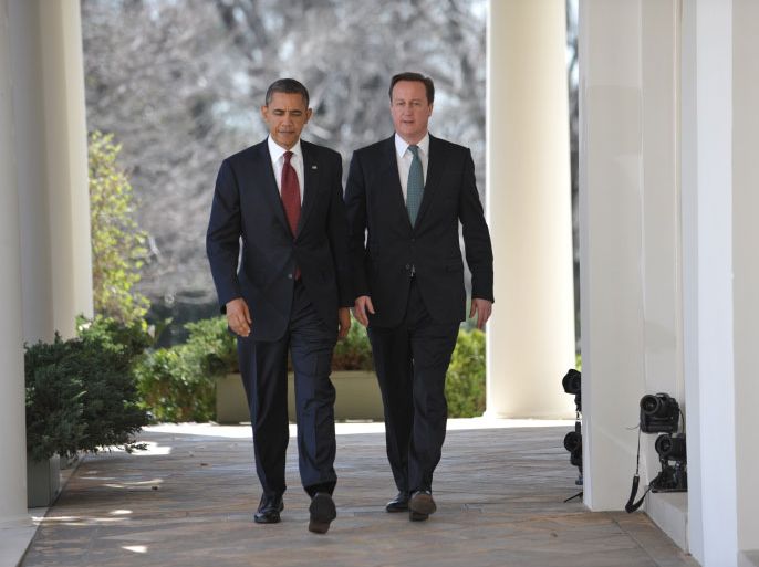 US President Barack Obama (L) and British Prime Minister David Cameron make their way through the Colonnade for a joint press conference in the Rose Garden on March 14, 2012 at the White House in Washington, DC. AFP PHOTO/Mandel NGAN