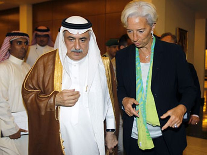 r_France's Finance Minister Christine Lagarde (R) speaks with her Saudi counterpart Ibrahim al-Assaf, after a news conference in Jeddah June 11, 2011.