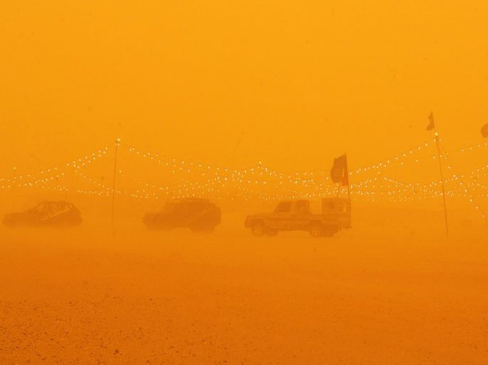 Cars are parked in a camp in Rawdatayn desert, 100 Kms North of Kuwait city as a heavy sandstorm hits the country on March 17,2012. AFP PHOTO/ TOPSHOTS/ YASSER AL-ZAYYAT