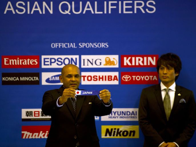 Windsor John (C), executive director of the AFC, flanked by Japan's former footballer Tsuneyasu Miyamoto (R) during the 2014 FIFA World Cup Brazil Asian qualifiers ceremony at the AFC headquarter in Bukit Jalil outside Kuala Lumpur on March 9, 2012. Japan shall be placed in position 5 in its group in order not to play on June 18, 2013 allowing the team to participate in the 2013 FIFA Confederation Cup to be held from June 16-30, 2013, as per the decision by AFC Executive Committee. AFP PHOTO / Saeed KHAN