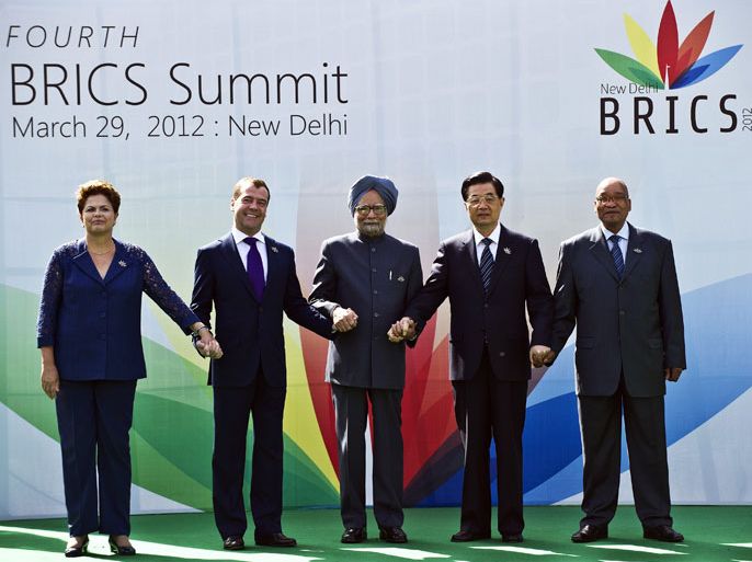 New Delhi, -, INDIA : Heads of the BRICS countries (L to R) President Dilma Rousseff of Brazil, Russian President Dimitry Medvedev, Indian Prime Minister Manmohan Singh, Chinese President Hu Jintao and President Jacob Zuma of South Africa pose prior to the BRICS summit in New Delhi on March 29, 2012. The leaders of BRICS countries gathered for their fourth summit, with the emerging market bloc struggling to convert its growing economic strength into collective diplomatic clout. Brazil, Russia, India, China and South Africa represent 40 percent of humanity, but their grouping faces persistent questions over whether it can unite on key issues given the different priorities of its members. AFP PHOTO / Prakash SINGH