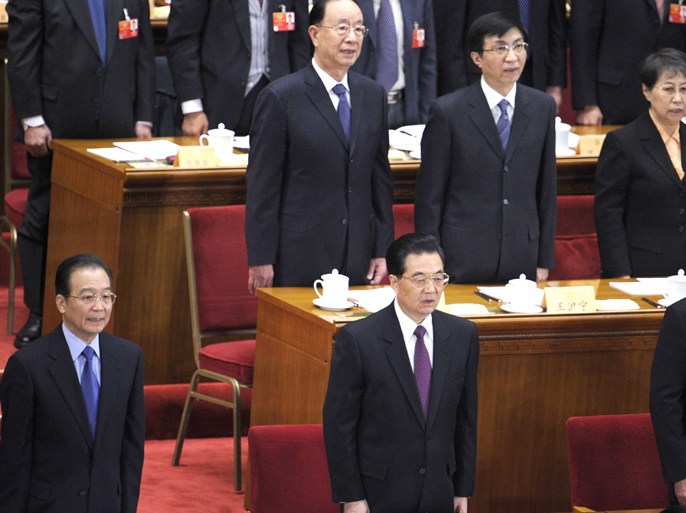 Chinese President Hu Jintao (C), Prime Minister Wen Jiabao (L) and China's Chairman of the Standing Committee of the National People's Congress Wu Bangguo (R) sing the national anthem during the opening session of the 11th National Committee of the Chinese People's Political Consultative Conference (CPPCC) at the Great Hall of the People in Beijing on March 3, 2012. China's parliament will open its last annual session under the current leadership on March 5, amid what analysts say may be a bitter power struggle to replace outgoing Communist Party rulers. AFP PHOTO