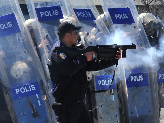 A Turkish riot policeman uses tear gas to disperse Kurdish protesters during a Noruz celebration in Istanbul, on March 18,2012. Thousands of Kurds clashed with police in Istanbul and the southern city of Diyarbakir after police used water cannon and tear gas to try and stop Kurdish New Year festivities.