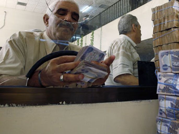 reuters\ a client counts his money at al-rafidain bank in baghdadjune 21, 2009. total bank deposits in february -- the latest figures available -- jumped by half to 36.6 trillion (رويترز)